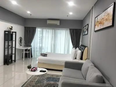 a bedroom with a bed and a couch in a room at Mercu Summer Suites Klcc by Luxe Residence in Kuala Lumpur