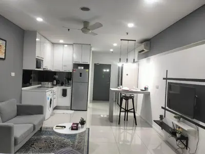 a kitchen and living room with a couch and a table at Mercu Summer Suites Klcc by Luxe Residence in Kuala Lumpur