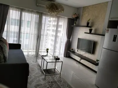 a living room with a couch and a tv at Mercu Summer Suites Klcc by Luxe Residence in Kuala Lumpur