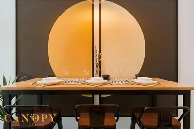 a table with two chairs and a table with glasses on it at The Luxe & The Colony, KLCC in Kuala Lumpur