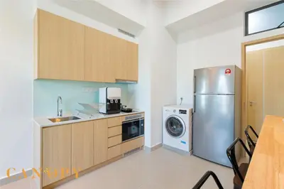a kitchen with a refrigerator and a washer and dryer at The Luxe & The Colony, KLCC in Kuala Lumpur