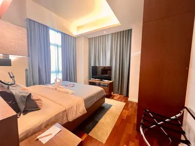 a hotel room with a bed and a television at Suites TribecaTRX Kuala Lumpur by ZenGlo 5min walk to The Exchange TRX in Kuala Lumpur