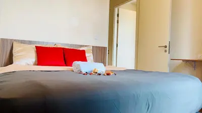 a bedroom with a large bed with red pillows at Suites TribecaTRX Kuala Lumpur by ZenGlo 5min walk to The Exchange TRX in Kuala Lumpur