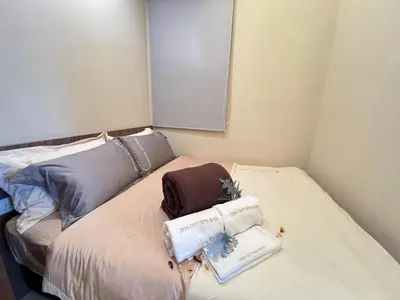 a room with a bed with two books on it at Suites TribecaTRX Kuala Lumpur by ZenGlo 5min walk to The Exchange TRX in Kuala Lumpur