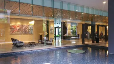 a lobby with a swimming pool in a building at M City with Pool KLCC city view in Kuala Lumpur