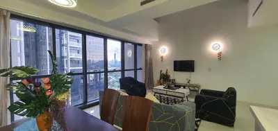 a living room with a table and chairs and a large window at M City with Pool KLCC city view in Kuala Lumpur