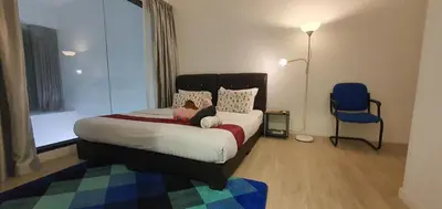 a bedroom with a bed with a teddy bear on it at M City with Pool KLCC city view in Kuala Lumpur