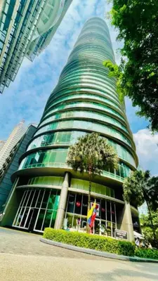 a tall building with a tree in front of it at VORTEX STAR KLCc APARTMENT in Kuala Lumpur