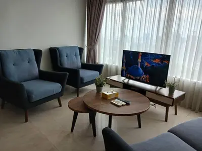 a living room with two chairs and a coffee table at VORTEX STAR KLCc APARTMENT in Kuala Lumpur