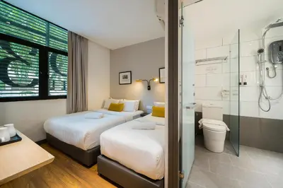 a hotel room with two beds and a shower at Gold3 Boutique Hotel in Kuala Lumpur