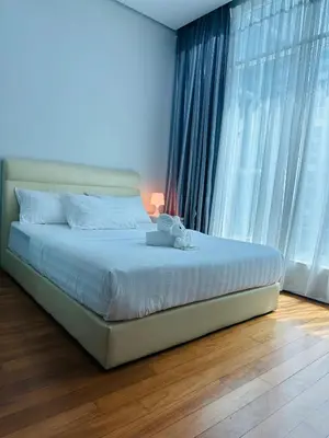 a bed in a bedroom with a large window at Soho Suites KLCC by Angel in Kuala Lumpur