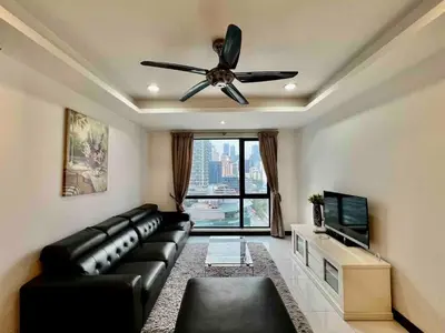 a living room with a black leather couch and a ceiling fan at BBHomes at Casa Residency KL in Kuala Lumpur
