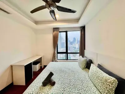 a bedroom with a bed with a ceiling fan and a window at BBHomes at Casa Residency KL in Kuala Lumpur