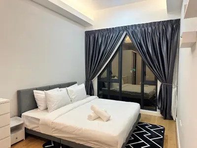 a bedroom with a bed and a large window at Quill Suites KLCC in Kuala Lumpur