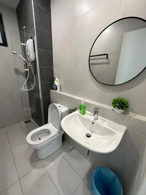 a bathroom with a toilet and a sink and a mirror at family suite Laville#velocity maluri by Homeizing in Kuala Lumpur