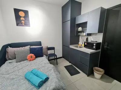 a bedroom with a bed with blue pillows on it at Blue Small Studio Near KLCC in Kuala Lumpur