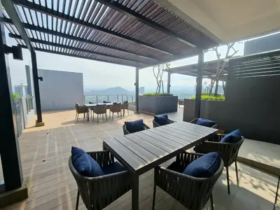 a patio with a wooden table and chairs with a view at Blue Small Studio Near KLCC in Kuala Lumpur