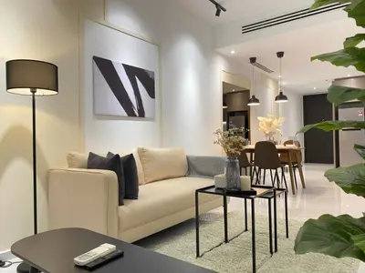 a living room with a couch and a table at Eaton Suites KLCC Kuala Lumpur in Kuala Lumpur