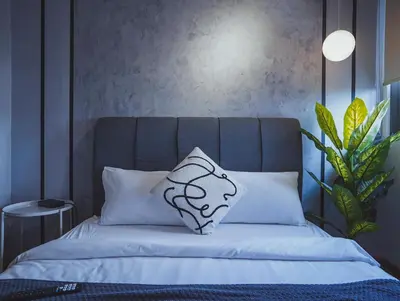 a bed with a pillow on top of it at Riveria City KL Sentral by Sky Pool Minshuku in Kuala Lumpur
