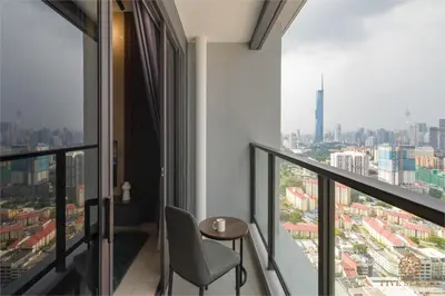 a balcony with a table and a view of a city at Trion Kuala Lumpur by Five Senses in Kuala Lumpur