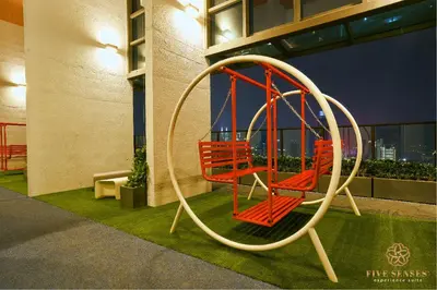 a playground in a building with two red chairs at Trion Kuala Lumpur by Five Senses in Kuala Lumpur