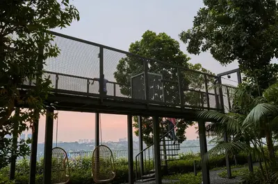 a walkway in a park with a bridge at Trion Kuala Lumpur by Five Senses in Kuala Lumpur