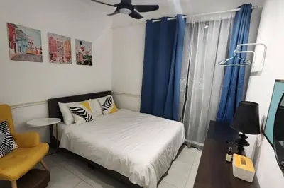 a bedroom with a bed and a window with blue curtains at The Nova by The City Collection II in Kuala Lumpur