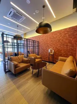 a lobby with two couches and a brick wall at The Nova by The City Collection II in Kuala Lumpur