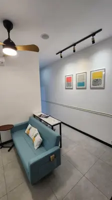 a room with a blue couch in a room at The Nova by The City Collection II in Kuala Lumpur