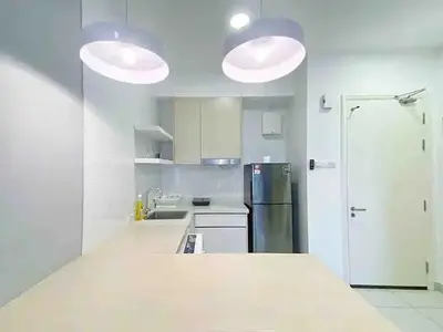 a kitchen with white counters and a refrigerator at Regalia Resident by Great Stay in Kuala Lumpur