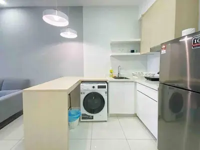 a kitchen with a washing machine in a white kitchen at Regalia Resident by Great Stay in Kuala Lumpur