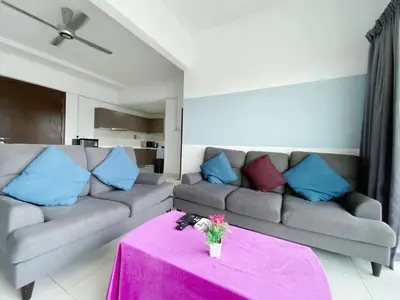 a living room with a couch and a pink table at Regalia Resident by Great Stay in Kuala Lumpur