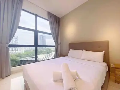 a bedroom with a white bed with a large window at Regalia Resident by Great Stay in Kuala Lumpur
