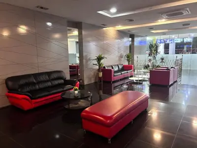 a lobby with couches and chairs and a table at Private Jacuzzi Suite - Pertama Residency in Kuala Lumpur