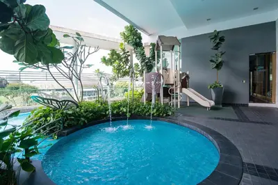 a large swimming pool in a room with plants at Yelloduck Rooms & Apartment @ Casa Residency in Kuala Lumpur