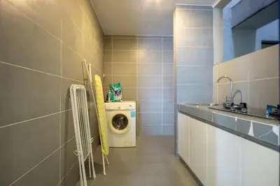 a laundry room with a washer and a washing machine at Yelloduck Rooms & Apartment @ Casa Residency in Kuala Lumpur