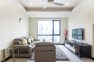 a living room with a couch and a tv at Yelloduck Rooms & Apartment @ Casa Residency in Kuala Lumpur