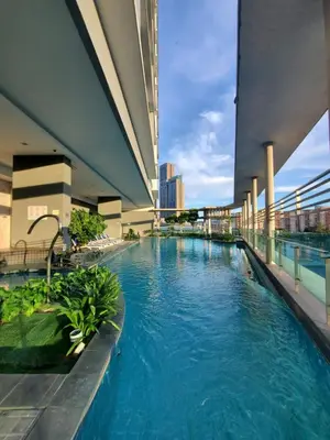 a swimming pool in the middle of a building at Yelloduck Rooms & Apartment @ Casa Residency in Kuala Lumpur