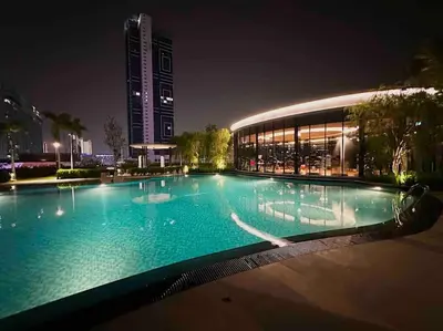 a large swimming pool in front of a building at night at Trion KL 10mins to KLCC-Lalaport-Velocity 6 Pax in Kuala Lumpur