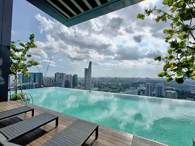 a large swimming pool on top of a building at KL Eco City Apartment by Homeizing in Kuala Lumpur