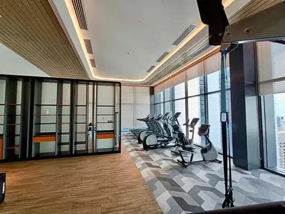 a gym with treadmills and ellipticals in a building at KL Eco City Apartment by Homeizing in Kuala Lumpur