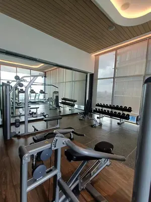 a gym with a bunch of cardio equipment in it at KL Eco City Apartment by Homeizing in Kuala Lumpur
