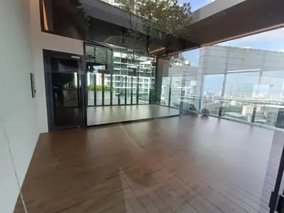 a large room with a wooden floor and glass windows at KL Eco City Apartment by Homeizing in Kuala Lumpur