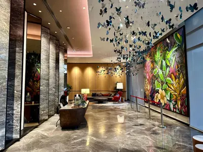 a lobby with a large painting of butterflies on the wall at KL Eco City Apartment by Homeizing in Kuala Lumpur