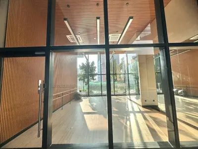 an empty hallway with glass doors in a building at Luxury 2BR KL View, Infinity Pool, Walk to Pavilion and Jalan Alor in Kuala Lumpur