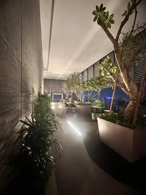 a building with a courtyard with plants and a tree at Luxury 2BR KL View, Infinity Pool, Walk to Pavilion and Jalan Alor in Kuala Lumpur