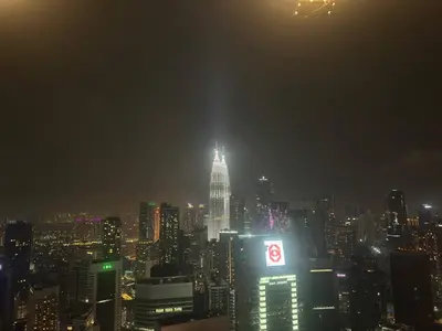 a view of a city skyline at night at Luxury 2BR KL View, Infinity Pool, Walk to Pavilion and Jalan Alor in Kuala Lumpur
