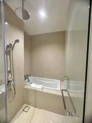 a bathroom with a shower and a bath tub at Luxury 2BR KL View, Infinity Pool, Walk to Pavilion and Jalan Alor in Kuala Lumpur
