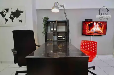 a room with a table and two chairs and a fireplace at Cozy Duplex Studio near Kuala Lumpur next to LRT Train Station in Ampang