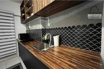 a kitchen with a sink and a black and white wall at Cozy Duplex Studio near Kuala Lumpur next to LRT Train Station in Ampang
